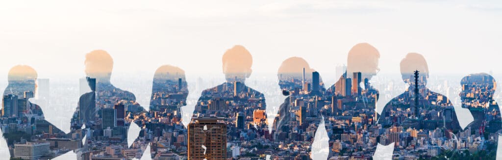 Image of people conversing in front of a city.