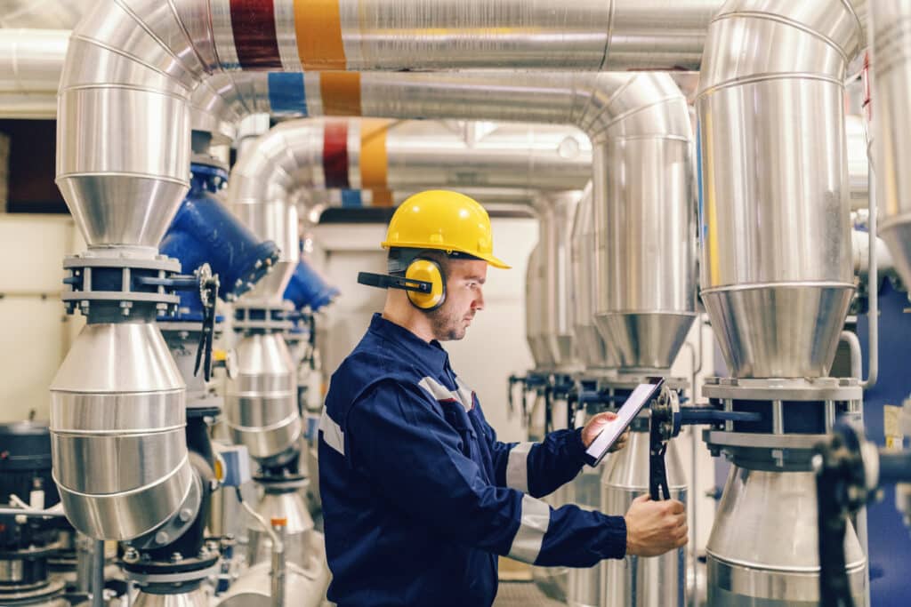 Picture of worker checking machine conditions